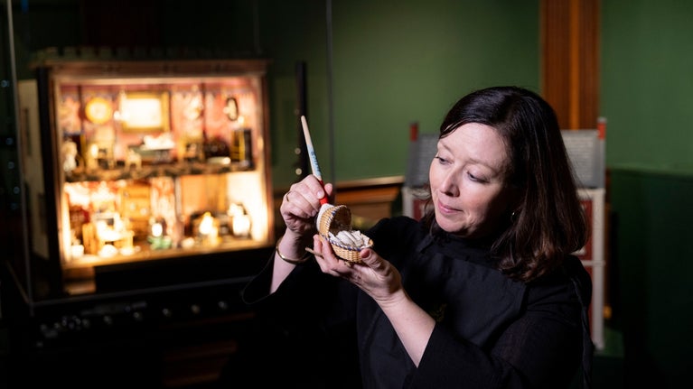 Katy Canales, Hill Top Property Curator, with an item from Beatrix Potters Dolls' House